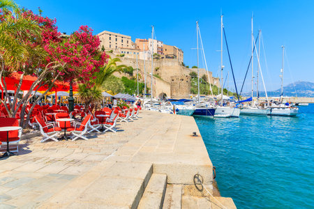 CALVI, CORSICA ISLAND - JUN 28, 2015: view of restaurant and citadel with houses in Calvi port. This town has luxurious marina aのeditorial素材
