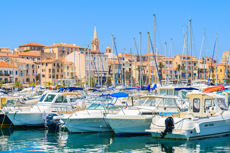 CALVI, CORSICA ISLAND - JUN 28, 2015: view of sailing boats and houses in Calvi port. This town has luxurious marinaのeditorial素材