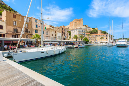 BONIFACIO PORT, CORSICA ISLAND - JUN 23, 2015: sailing boats in Bonifacio port on sunny summer day, Corsica island, France.のeditorial素材