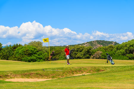 CORSICA ISLAND, FRANCE - JUN 25, 2015: Golfer on green grass area of golf course playing area on Corsica island, France.のeditorial素材