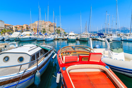 CALVI PORT, CORSICA ISLAND - JUN 28, 2015: stylish retro motor boat mooring in Calvi marina on western coast of Corsica island,のeditorial素材