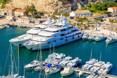 BONIFACIO PORT, CORSICA ISLAND - JUN 24, 2015: two large luxury motor boats mooring in Bonifacio townのeditorial素材