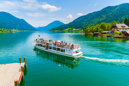 WEISSENSEE LAKE, AUSTRIA - JUL 6, 2015: tourist boat "Weissensee" departing for a cruise around Weissensee lake in summer landscapeのeditorial素材