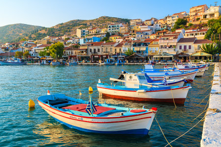 SAMOS ISLAND, GREECE - SEP 18, 2015: colorful Greek fishing boats in Pythagorion port at sunset time.のeditorial素材
