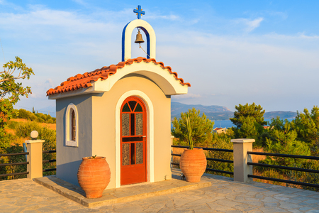 Small Greek chapel on coast of Samos island in warm sunset light, Greeceの写真素材