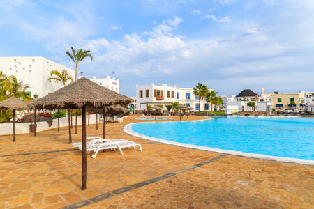 PLAYA BLANCA, LANZAROTE ISLAND - JAN 17, 2015: swimming pool of luxury apartment complex built in traditional Canary style on Lanzarote island.のeditorial素材