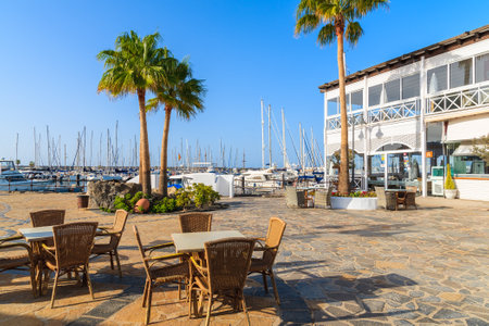 MARINA RUBICON, LANZAROTE ISLAND - JAN 14, 2015: restaurant tables with chairs in Rubicon yacht port. Lanzarote is most northern island in Canary Islands archipelago.のeditorial素材