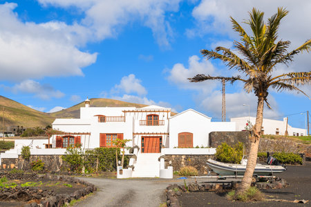 LANZAROTE ISLAND, SPAIN - JAN 17, 2015: typical Canarian house in tropical landscape of Lanzarote island, Spain. Many Europeans buy properties on Canary Islands due to sunny and warm climate.のeditorial素材