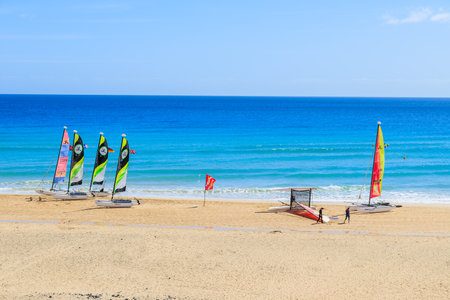 MORRO JABLE, FUERTEVENTURA - FEB 7, 2014: catamaran boats on beach in Morro Jable. This is a popular holiday resort on Fuerteventura island.のeditorial素材