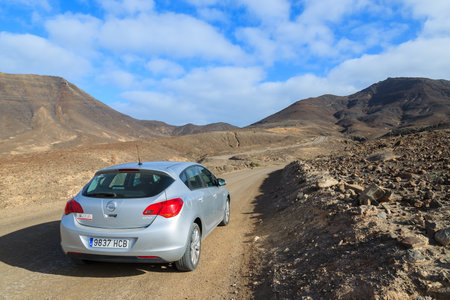 MORRO JABLE TO COFETE BEACH ROAD, FUERTEVENTURA - FEB 8, 2014: hire car on unpaved road to Cofete beach. This area is secluded part of Fuerteventura island.のeditorial素材