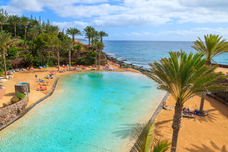 COSTA CALMA, FUERTEVENTURA - FEB 7, 2014: swimming pool in luxury hotel on coast of Fuerteventura island. Tropical gardens and man made lagoon are main attraction in this hotel.のeditorial素材