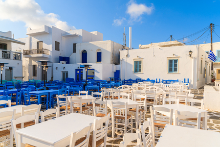 White and blue tavern tables on square in Naoussa port, Paros island, Greeceの写真素材