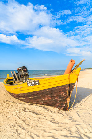 DEBKI BEACH, BALTIC SEA - JUN 22, 2016: typical colourful fishing boat on Debki beach on sunny beautiful summer day, coast of Baltic Sea, Poland.のeditorial素材