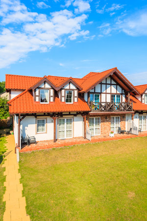 LEBA, POLAND - JUN 20, 2016: typical house built in Kashubian style in green garden in Leba town, Baltic Sea, Poland.のeditorial素材
