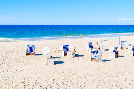 Wicker chairs on sandy beach in Kampen village, Sylt island, Germanyの写真素材