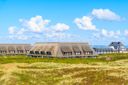 View of typical houses with straw roofs in Kampen village on western coast of Sylt island, Germanyの写真素材