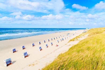 Chairs on sandy beach in List village, Sylt island, North Sea, Germanyの写真素材