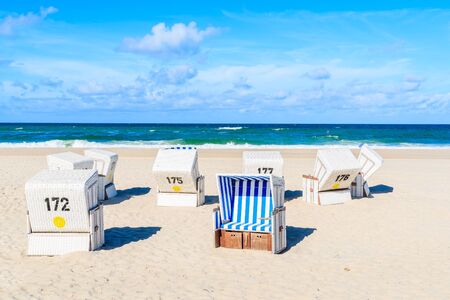 Chairs on white sand beach in Kampen village, Sylt island, Germanyの写真素材