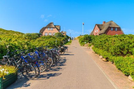 SYLT ISLAND, GERMANY - SEP 8, 2016: bikes parked along a street in Rantum village on southern coast of Sylt island, Germany.のeditorial素材