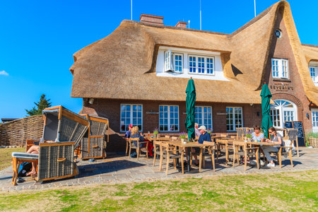 SYLT ISLAND, GERMANY - SEP 9, 2016: people dining in restaurant near Morsum cliff, Sylt island, Germany.のeditorial素材