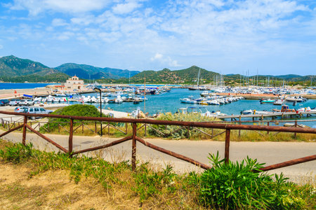 PORTO GIUNCO HARBOUR, SARDINIA - MAY 25, 2014: view of Porto Giunco touristic port with sailboats and yachts mooring, Sardinia island, Italy. Many tourists visit Sardinia island in summer time.のeditorial素材