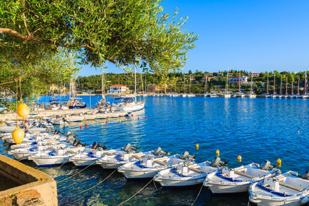 FISKARDO PORT, KEFALONIA ISLAND, GREECE - SEP 18, 2014: tourist boats for rent in port of (No Suggestions) village. Most tourists visit this village while visiting Kefalonia island.のeditorial素材