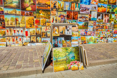 KRAKOW, POLAND - MAY 4, 2014: Paintings for sale hang on a wall in old town of Krakow. More than 10 Million tourists visit the city each year.のeditorial素材