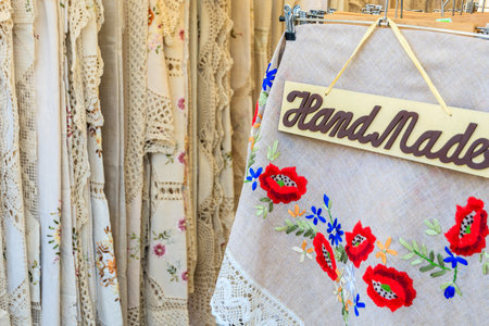 KRAKOW, POLAND - APR 13, 2014: traditional tablecloths with embroidered flower patterns on market stand in Krakow during Easter festival, Poland. Many tourists visit Krakow to buy them.のeditorial素材