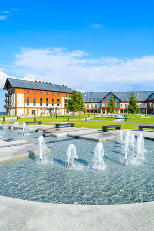 ARLAMOW HOTEL, POLAND - AUG 3, 2014: water fountain in beautiful Arlamow Hotel on sunny summer day. This luxury resort was owned by Poland's government and is located in Bieszczady Mountains.のeditorial素材