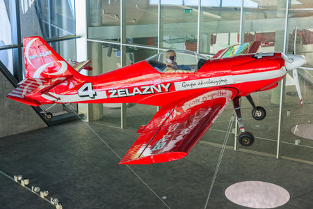 KRAKOW MUSEUM OF AVIATION, POLAND - JUL 27, 2014: red acrobatic plane hanging on exhibition in...
