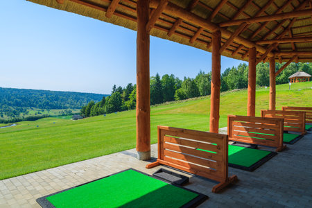 ARLAMOW GOLF COURSE, POLAND - AUG 3, 2014: beautiful golf play area on sunny summer day in Arlamow Hotel. This luxury hotel was owned by Poland's government and is located in Bieszczady Mountains.のeditorial素材