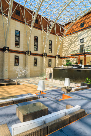 ARLAMOW HOTEL, POLAND - AUG 3, 2014: tables in beautiful open lobby restaurant in Arlamow Hotel. This luxury resort was owned by Poland's government and is located in Bieszczady Mountains.のeditorial素材