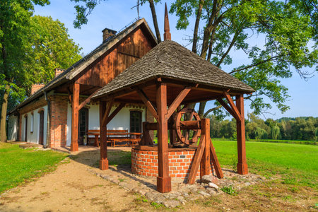 Water well of a traditional rural house in Radziejowice village on sunny summer day, Polandのeditorial素材