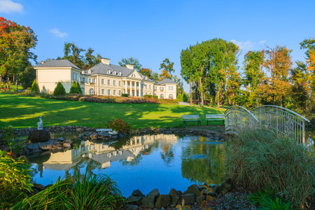 Reflection of Smilowice palace in small pond located in a green park, Polandのeditorial素材