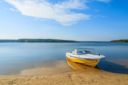 CHANCZA LAKE, POLAND - OCT 4, 2014: motor boat on shore of beautiful Chancza lake. Water sports are becoming more and more popular among Polish people.のeditorial素材