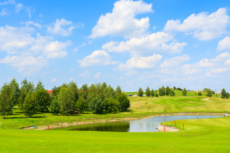 PACZULTOWICE GOLF CLUB, POLAND - AUG 9, 2014: lake on golf course green play area on sunny summer day. Golfing is becoming a popular sport among wealthy people from Krakow.のeditorial素材
