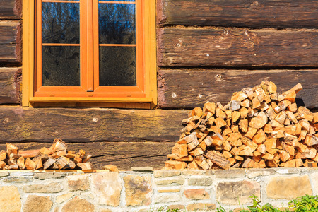 Pile of firewood stacked up in front of a house in Beskid Niski Mountains, Polandの写真素材