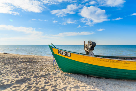 DEBKI BEACH, BALTIC SEA - JUN 22, 2016: typical colourful fishing boat on Debki beach on sunny beautiful summer day, coast of Baltic Sea, Poland.のeditorial素材