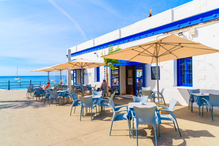 SANTA EULARIA TOWN, IBIZA ISLAND - MAY 21, 2017: Restaurant and drink bar with sea view on coastal promenade in Santa Eularia town, Ibiza island, Spain.のeditorial素材