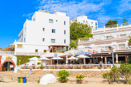 CALA PORTINATX BAY, IBIZA ISLAND - MAY 22, 2017: Hotel and restaurant buildings in Cala Portinatx bay on sunny summer day, Ibiza island, Spain.のeditorial素材