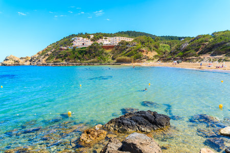 View of Es Figueral beach and hotel building on green hill, Ibiza island, Spainのeditorial素材