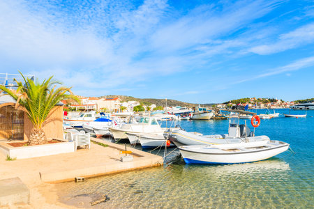 Fishing boats on beach with shallow crystal clear sea water in Rogoznica town, Dalmatia, Croatiaのeditorial素材