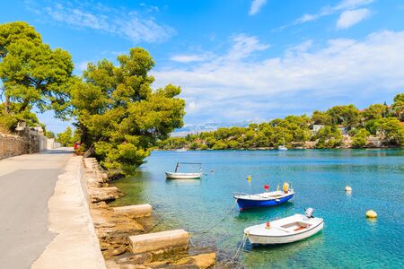 Fishing boats in beautiful sea bay in Splitska village on Brac island, Croatiaの写真素材