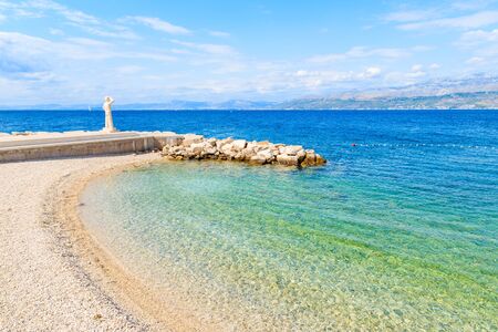 View of beach with turquoise sea water in Postira village, Brac island, Croatia