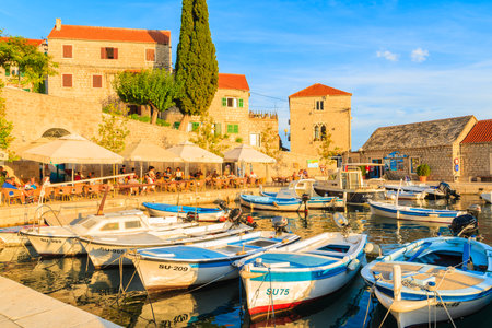 BOL PORT, CROATIA - SEP 12, 2017: Fishing boats in Bol port at sunset time, Brac island, Croatia.のeditorial素材