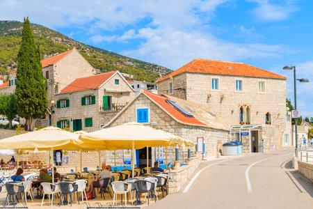 BOL PORT, BRAC ISLAND - SEP 8, 2017: People having drinks in Bol port restaurants, Brac island, Croatia.のeditorial素材