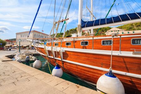 Wooden sailing boat and anchoring in Pucisca port on Brac island, Dalmatia, Croatiaの写真素材