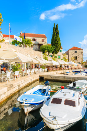 BOL PORT, BRAC ISLAND - SEP 8, 2017: Colorful fishing boats anchoring in Bol port, Brac island, Croatia.のeditorial素材
