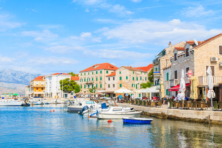 POSTIRA VILLAGE, BRAC ISLAND - SEP 7, 2017: Restaurant buildings and houses in Postira port, Brac island, Croatia.のeditorial素材