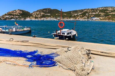 PORT ANDRATX, MAJORCA - APR 18, 2013: Fishing nets on shore in Port Andratx. This is popular among tourists seaside fishing village on Majorca island, Spain.のeditorial素材
